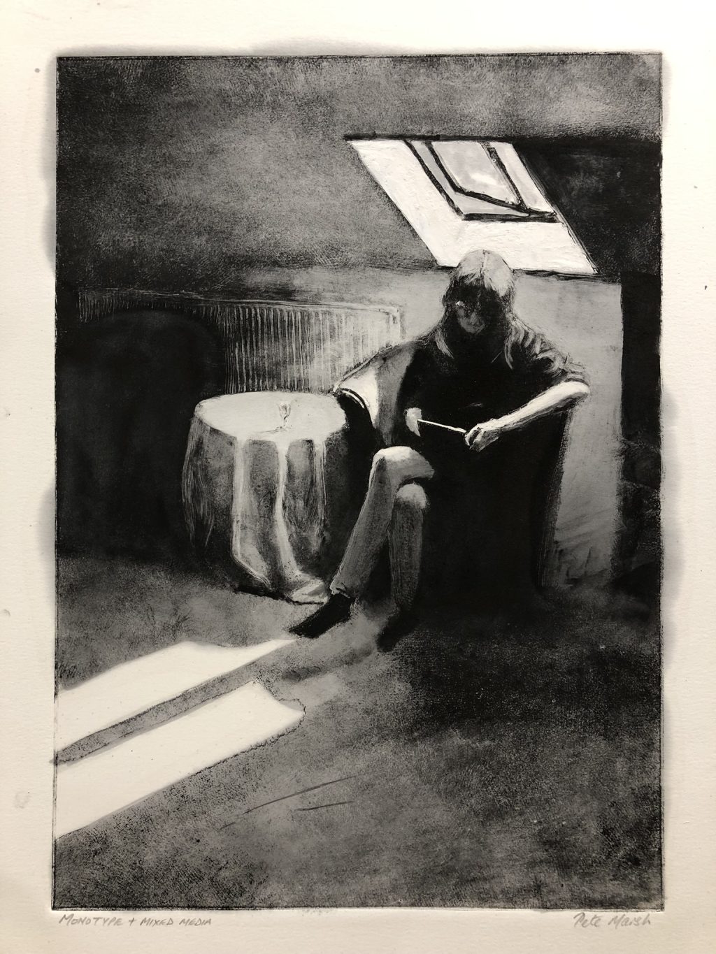 A woman reads in the light from a skylight.