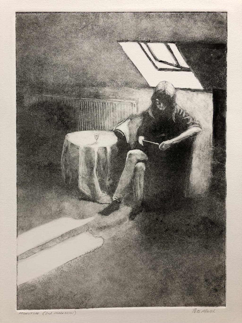 A woman reads in the light from a skylight.